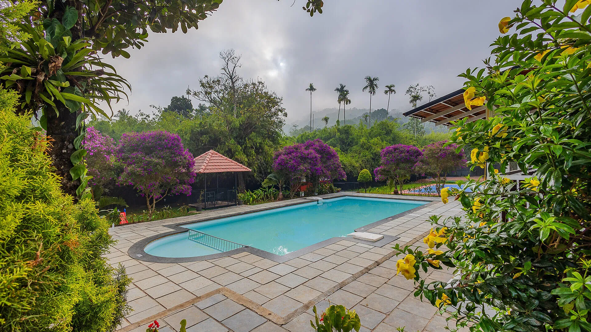 Poolside gardens at Karma Vythiri, a top resort in Wayanad Kerala