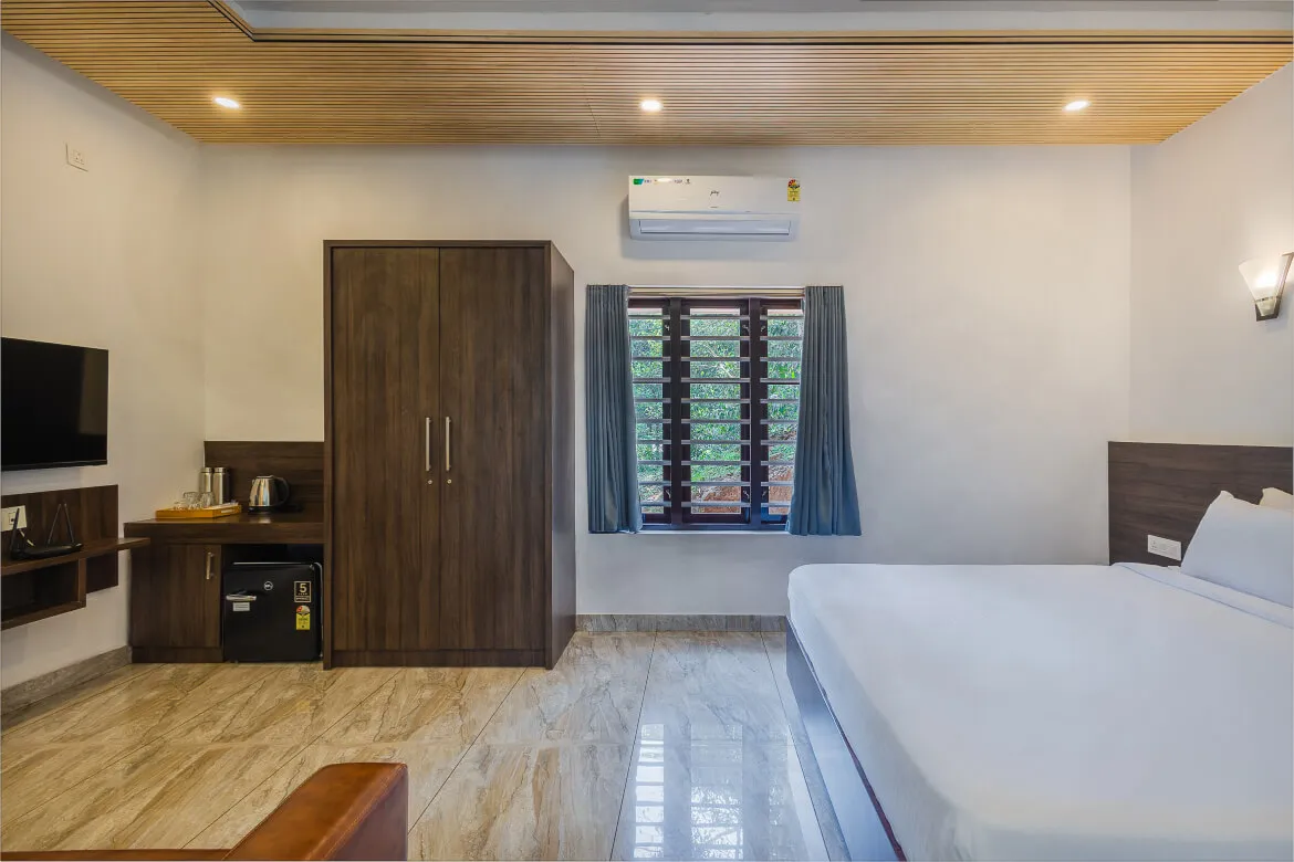 Hotel Unit Deluxe bedroom with forest view window, Karma Vythiri, Wayanad