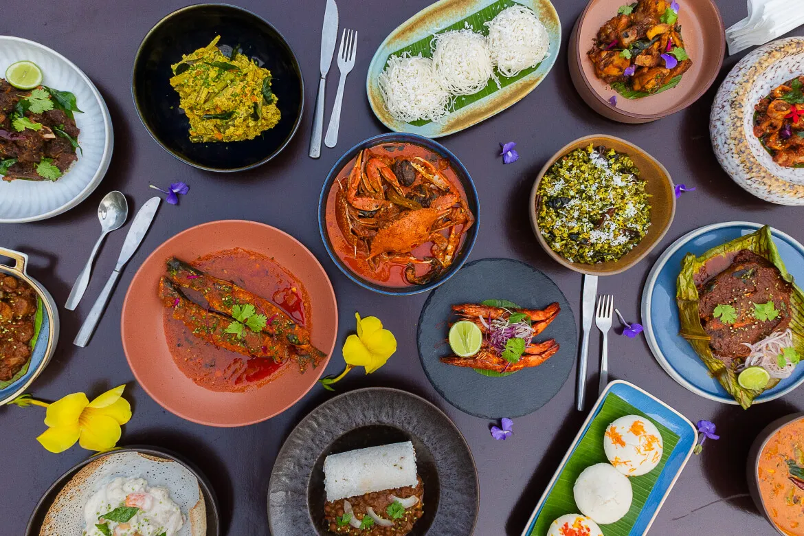 Overhead flat-lay of a Kerala seafood feast at Karma Vythiri restaurant