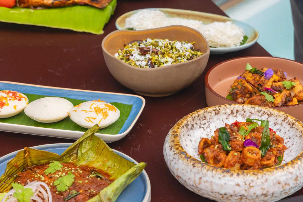 Squid masala and banana-leaf wrapped fish among a Kerala spread at Karma Vythiri