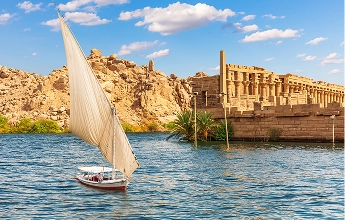 Felucca sailboat near Philae Temple ruins on the Nile