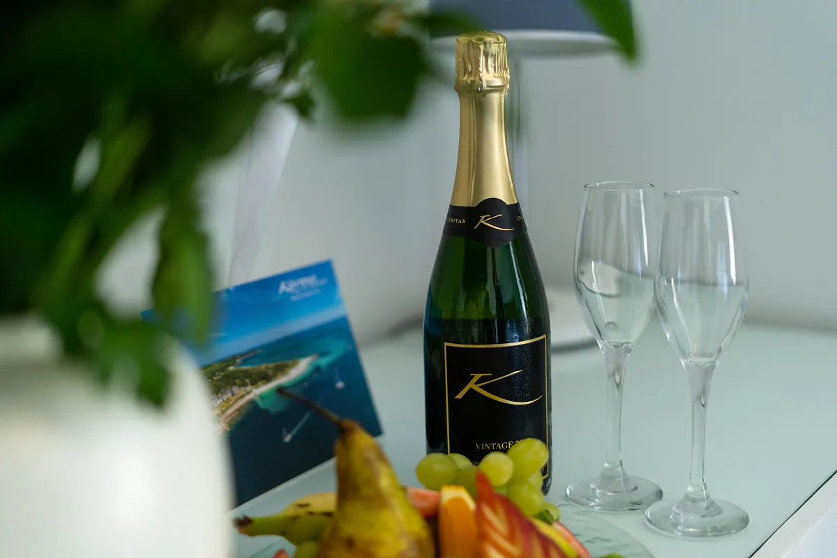 Welcome bottle of Karma K vintage sparkling wine with two glasses and fresh fruit at Karma St. Martin's