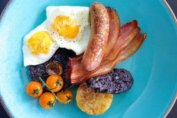Full English breakfast with eggs, bacon, sausage, black pudding and vine tomatoes at Karma St. Martin's