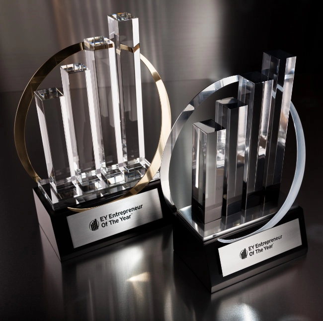 Two EY Entrepreneur of the Year crystal trophy awards