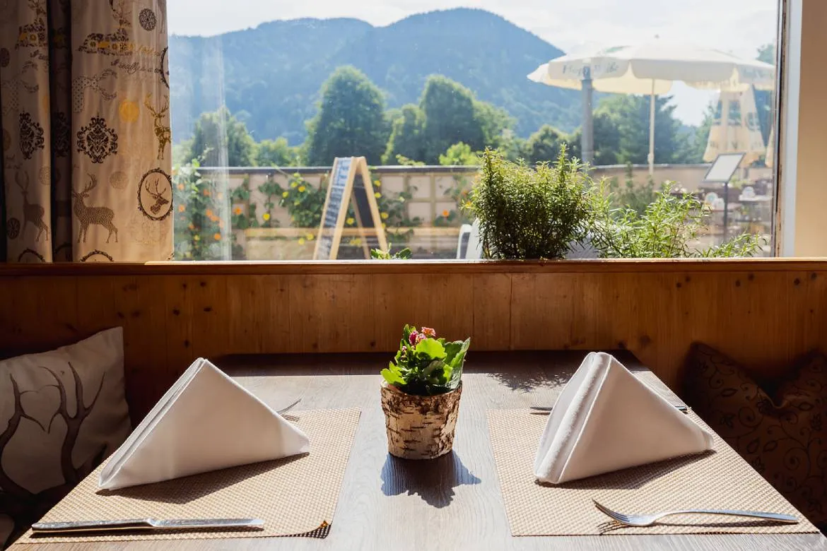 Window-side table with mountain views at Dario's Osteria, Karma Bavaria