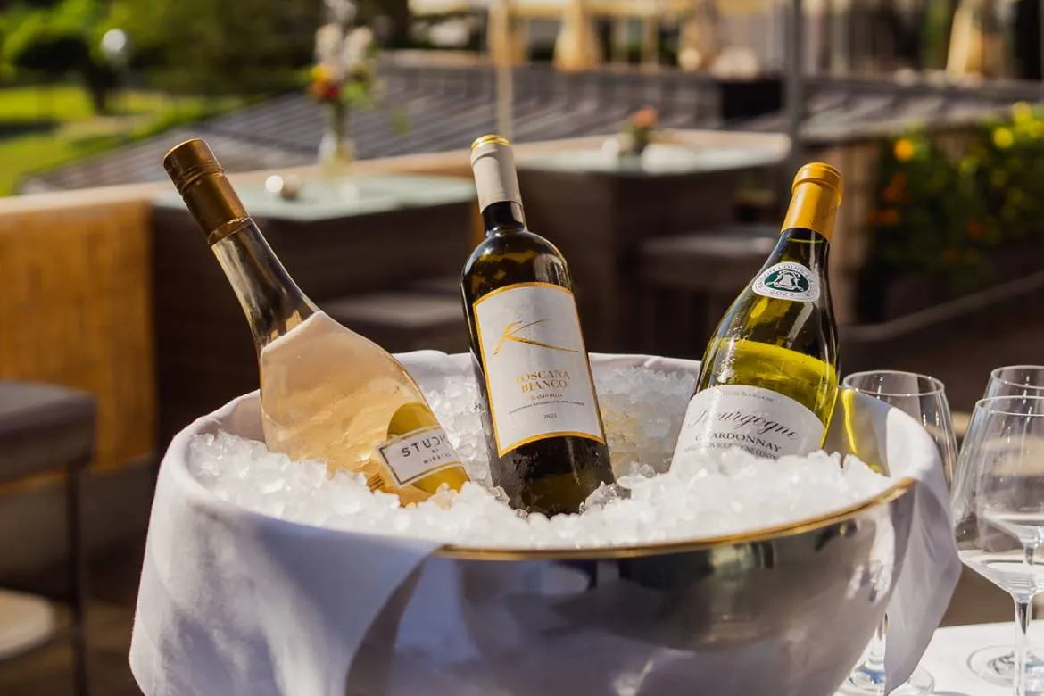 Chilled white wine selection on the terrace at Dario's Osteria, Karma Bavaria