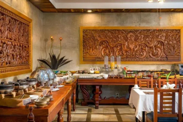 Interior buffet breakfast spread and carved wood decor at Karma Bayon Restaurant & Bar