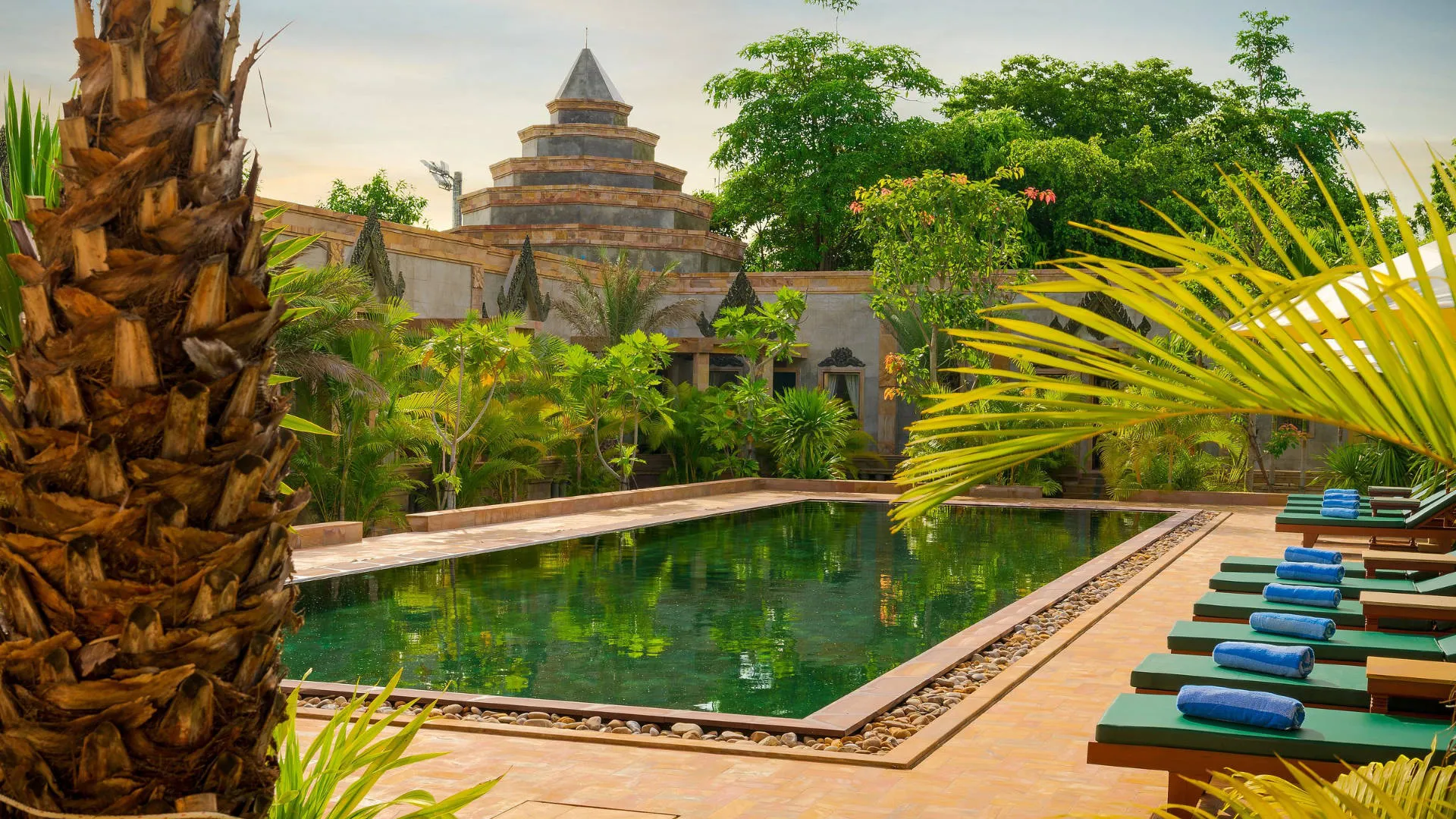 Tiered stone tower overlooking the pool at Karma Bayon