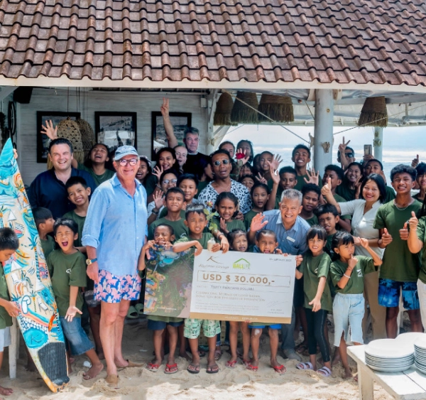Karma Group presenting a USD $30,000 donation check to a children's charity