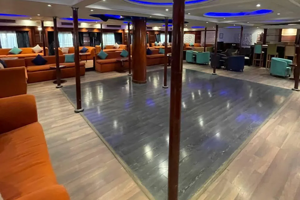 Lounge bar with orange sofas and dance floor at Karma Karnak