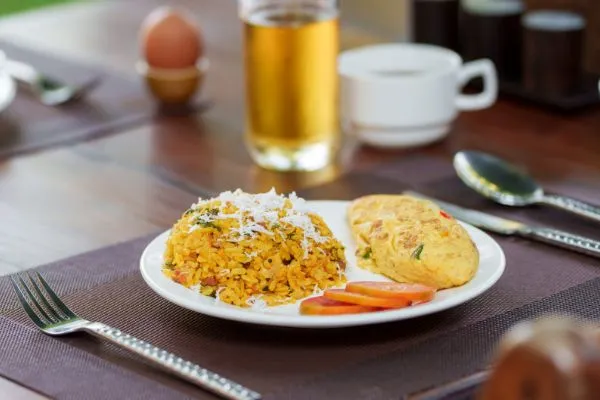 Breakfast plate with fried rice, omelet and tomato at Karma Bayon Restaurant & Bar