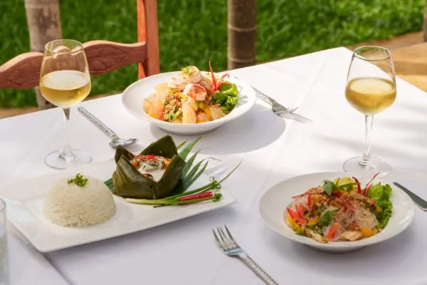 Banana leaf steamed dish with rice, salads and white wine at Karma Bayon Restaurant & Bar