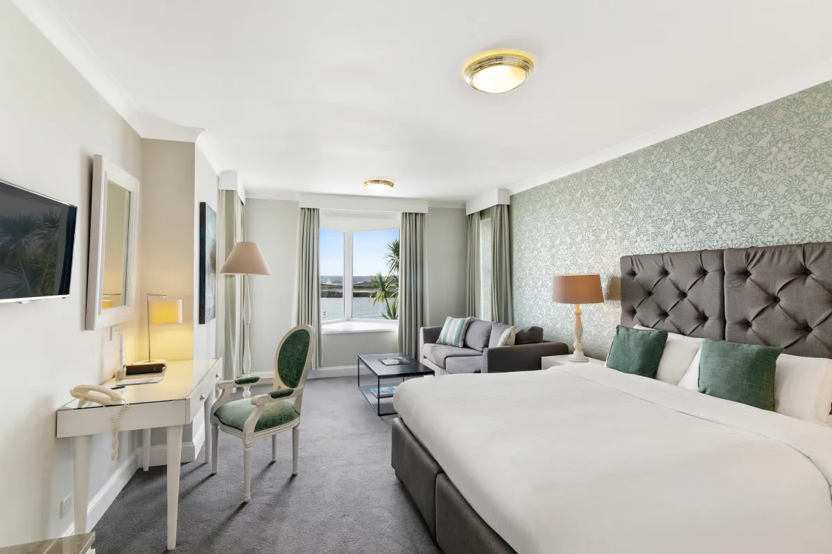 Spacious sea-view room at Karma St. Martin's, Isles of Scilly, with king bed, sofa and desk